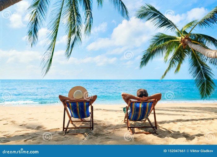 Vacation relaxing beach woman man couple chairs lounge mature